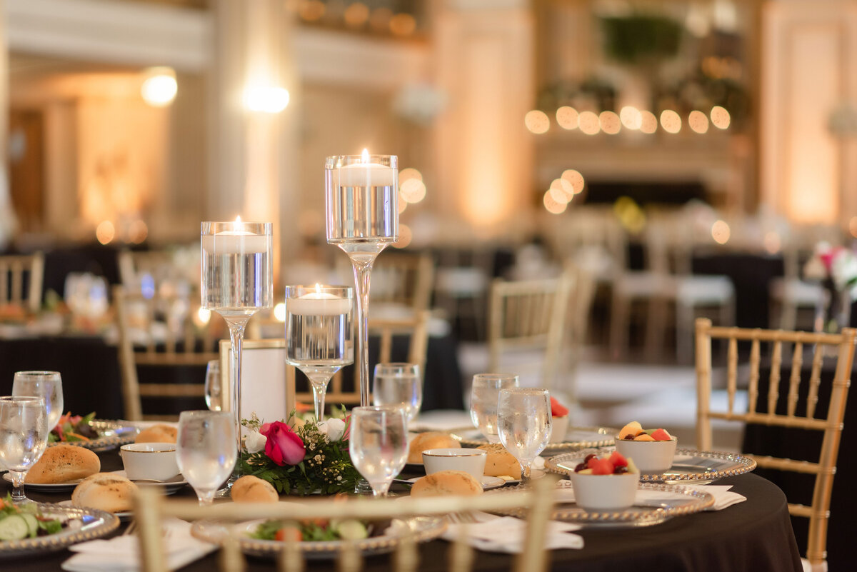 wedding reception setup with candles and delicious dinner in the grand ballroom at george washington hotel