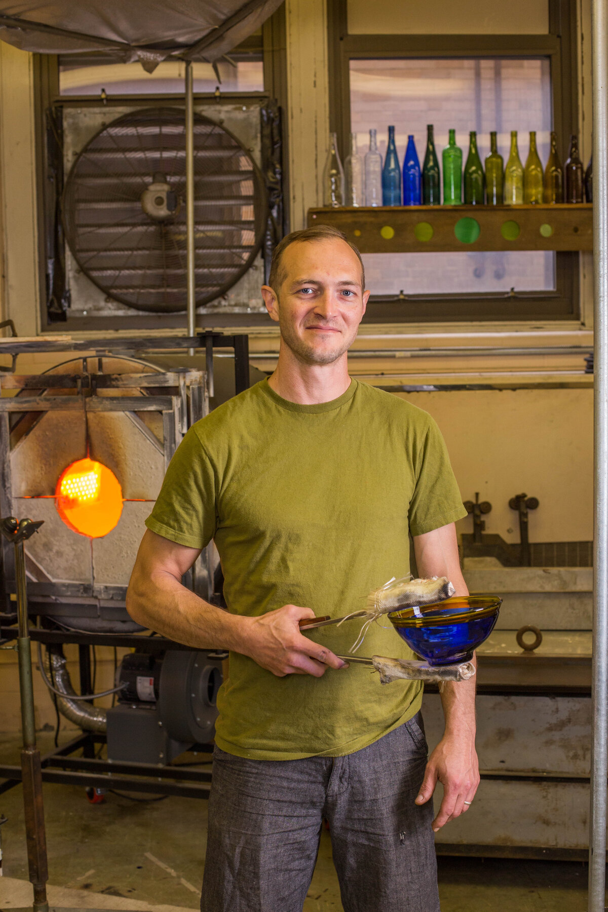 Business owner holding his product, blown glass bowl