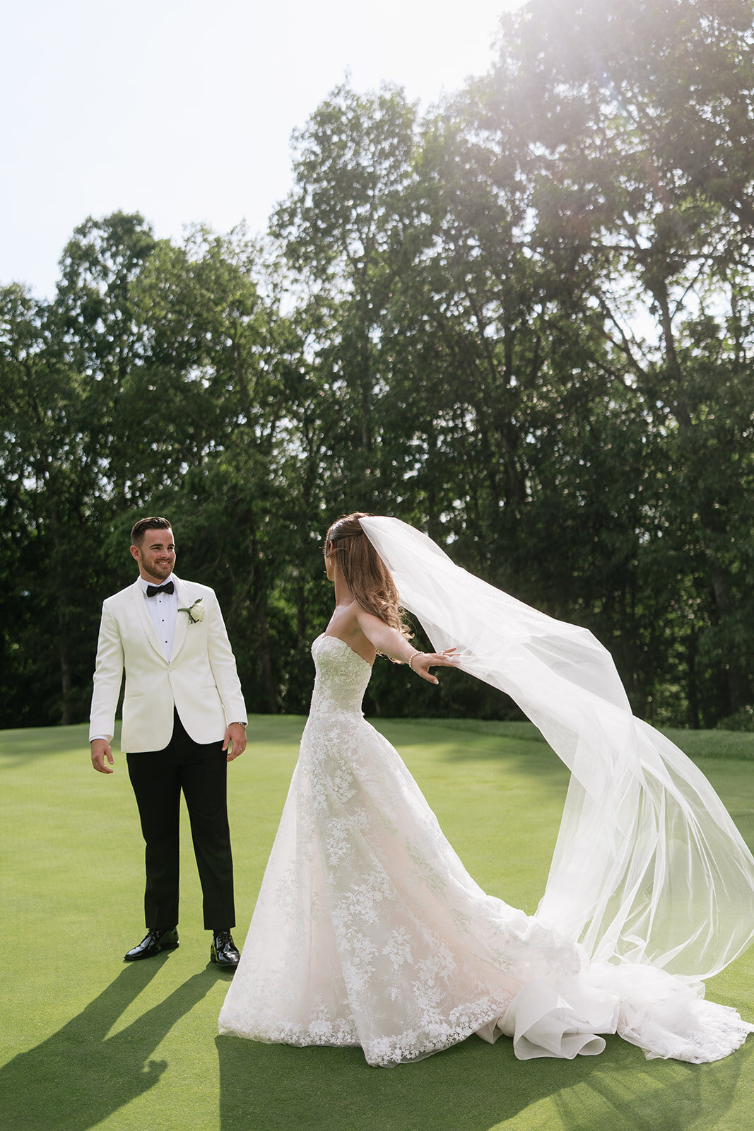 Bride and Groom smiling at each other on the golf course at Trillium Links and Lake Club in Cashiers, NC.