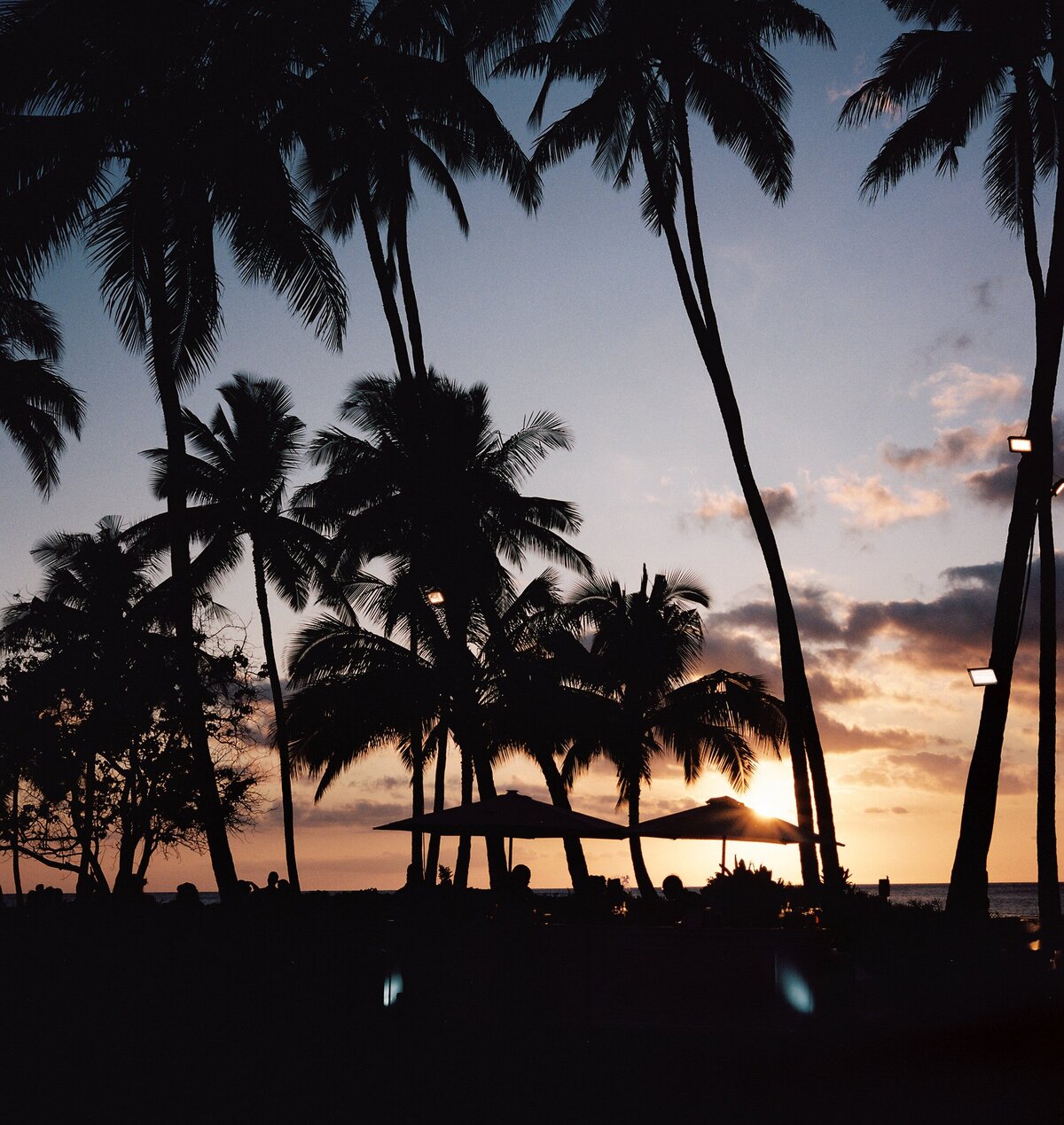 Stunning Hawaiian sunset captured on film, reflecting the beauty of a destination wedding — Carmel wedding photography by Kate Winters Photography.