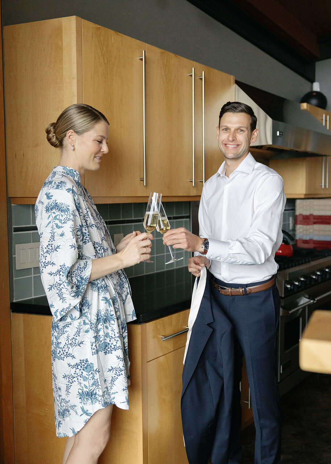 Bride and groom toasting champagne in a modern kitchen