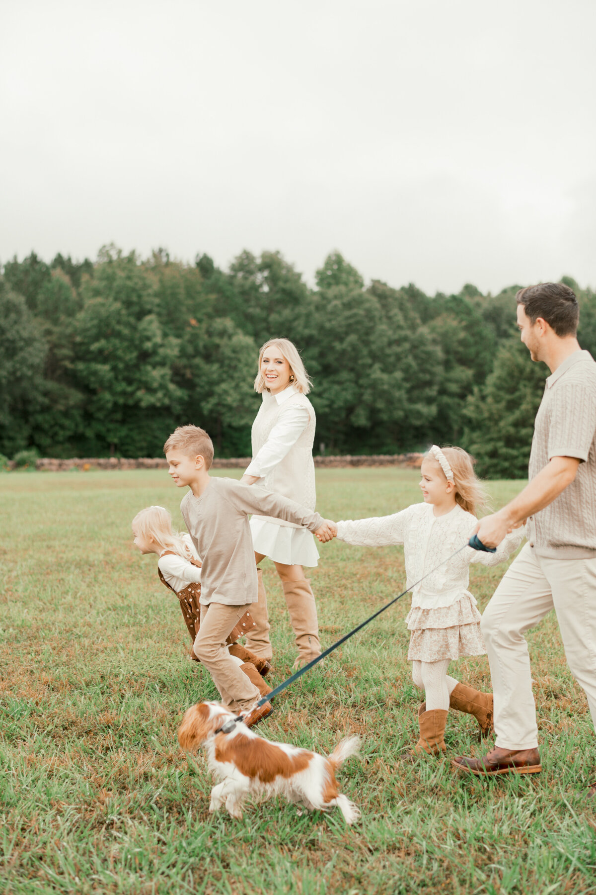 Family laughs and plays during a family session. Image by Raleigh maternity photographer A.J. Dunlap Photography.