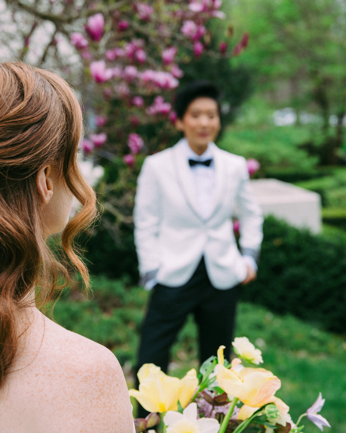 Two brides looking at each other on their wedding day.
