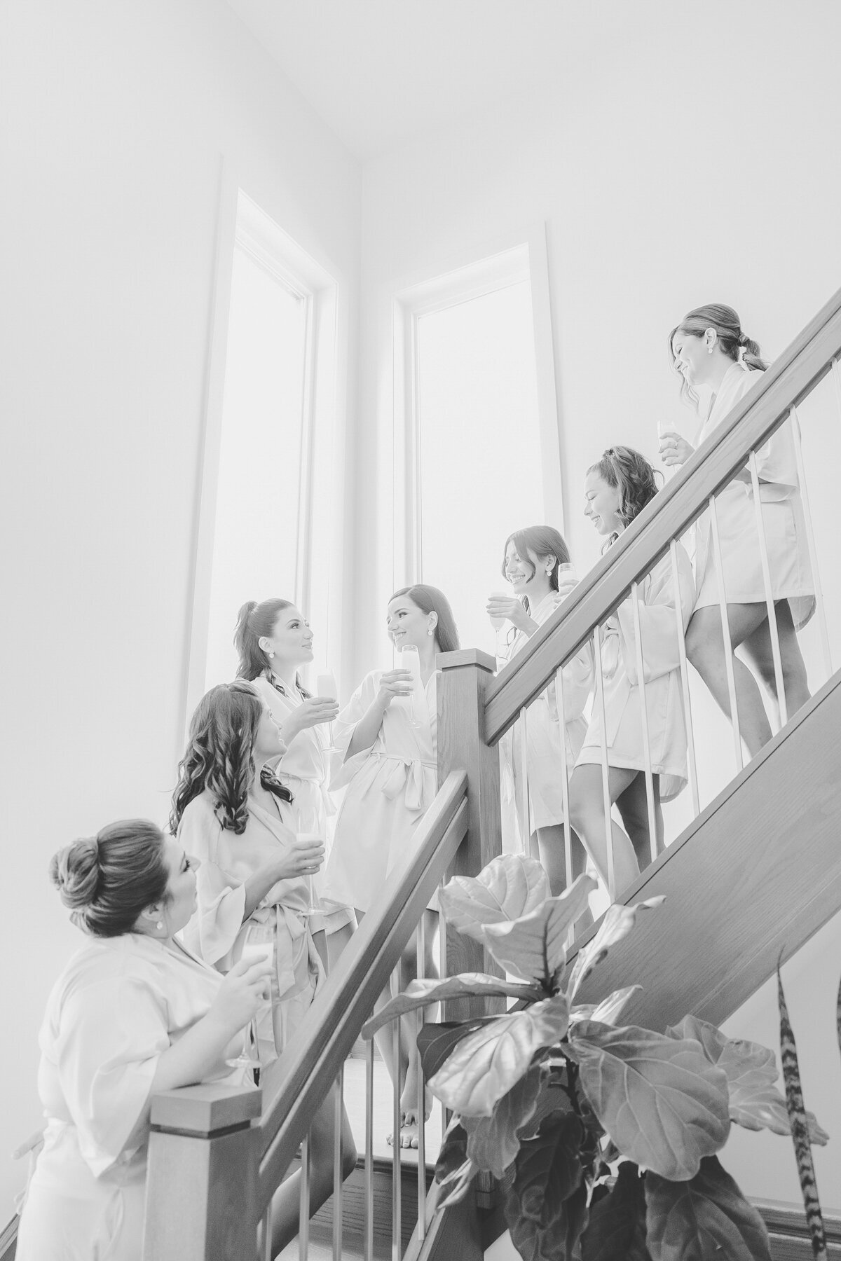 Bride and bridesmaids standing on a grand staircase