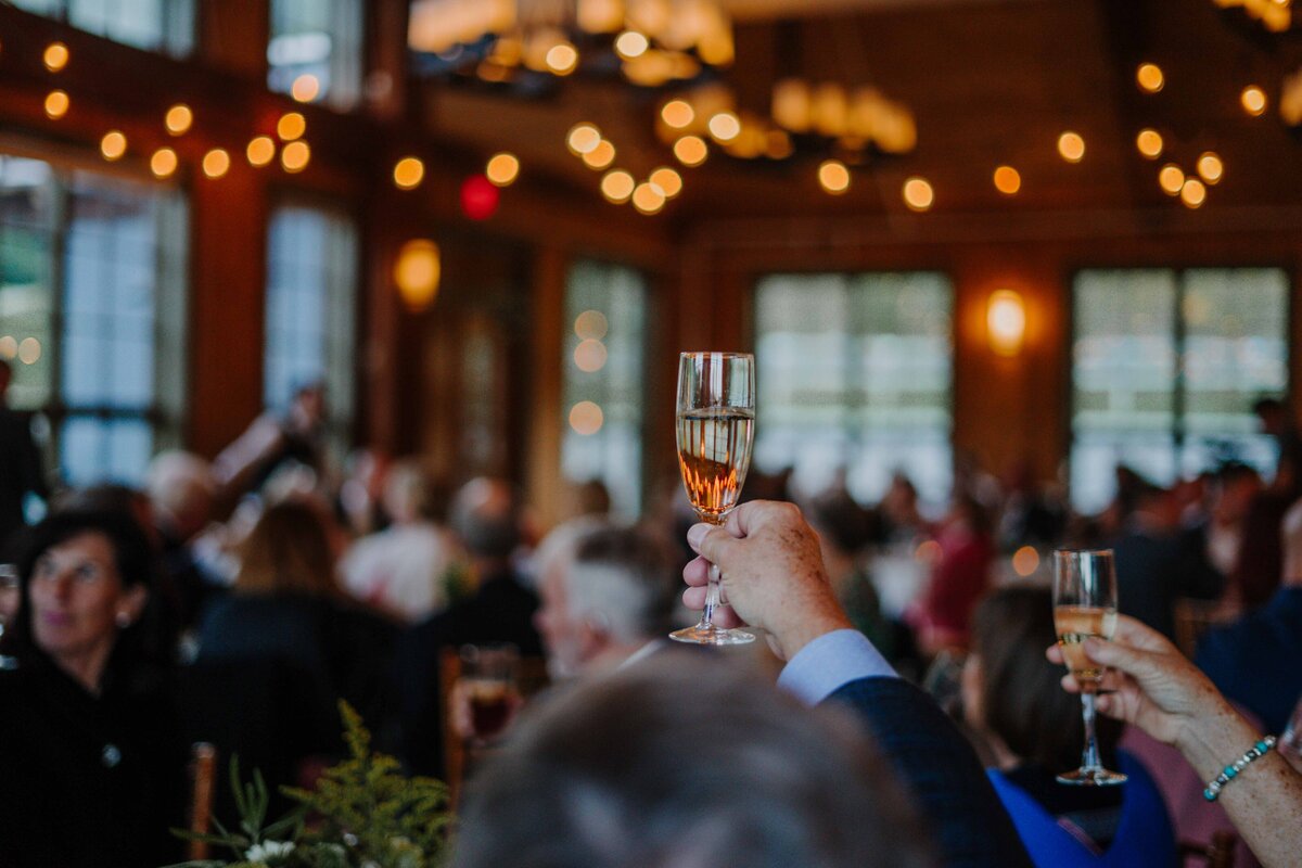 a man at a party cheersing their drink