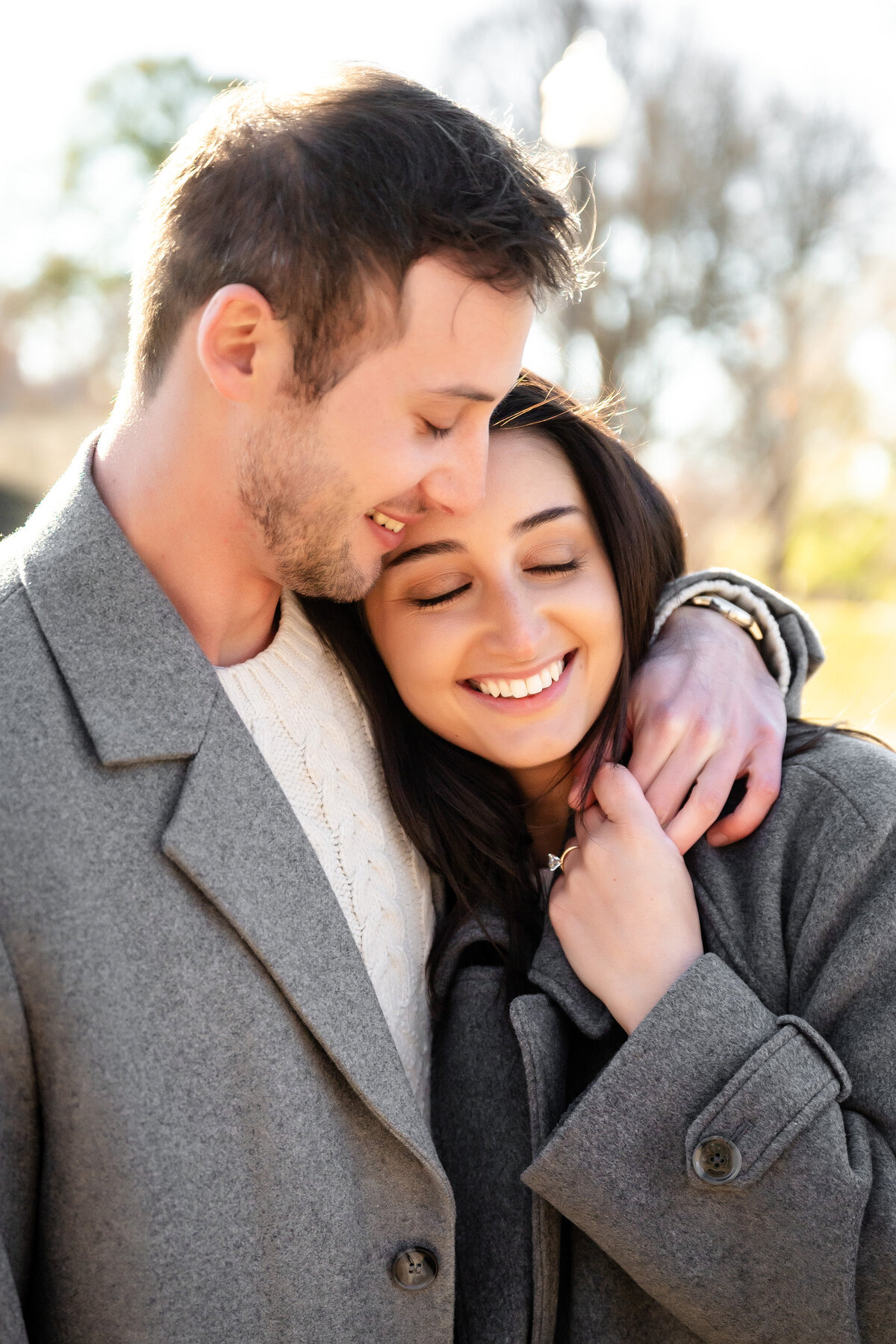 happy couple snuggling after they got engaged at allegheny commons west park pittsburgh