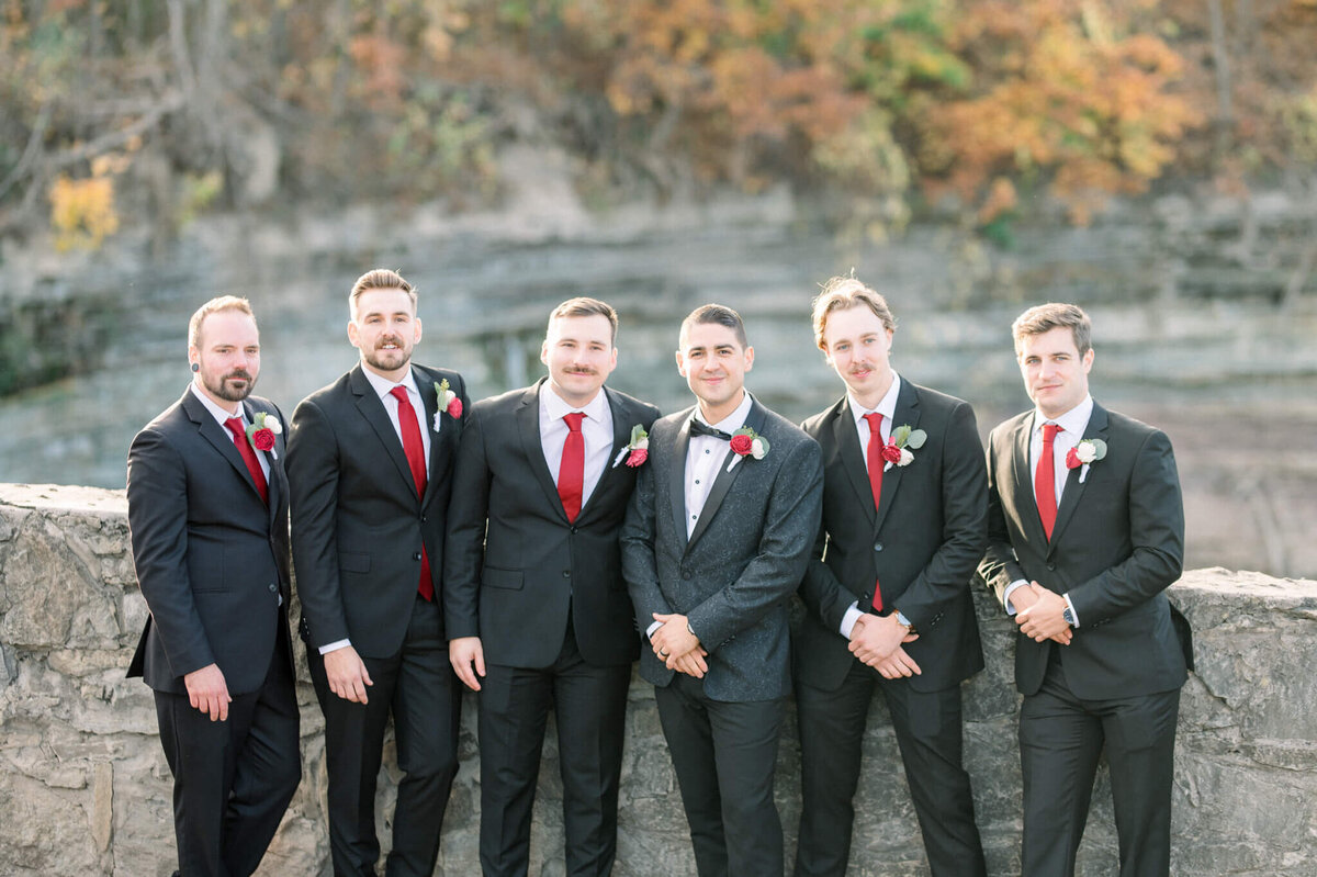 Men leaning on the wall at Balls Falls for their portrait captured by Niagara wedding photographer