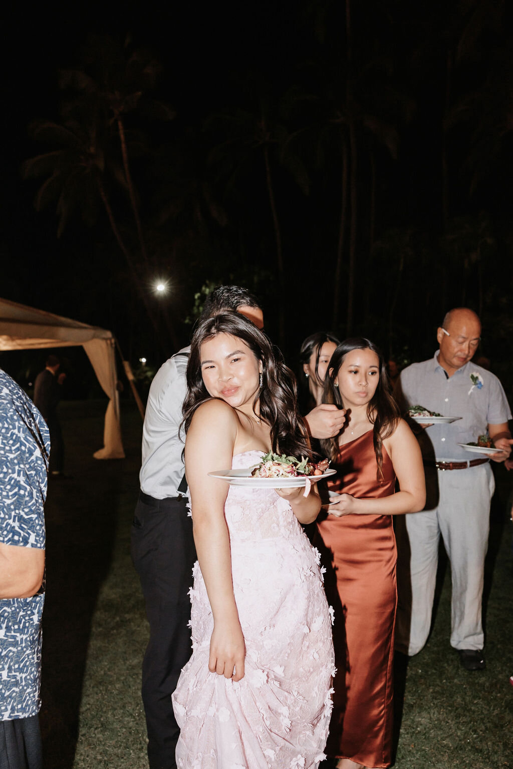 bridesmaid posing at wedding with her plate of food lanikuhonua