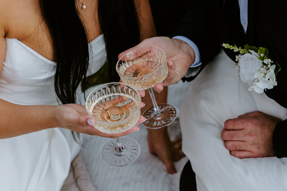 Close-up of couple toasting champagne glasses.