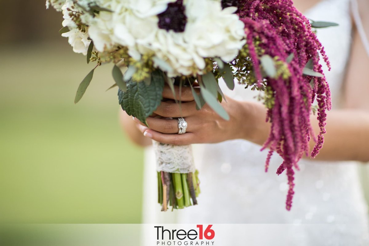 Bride showing off her ring and bouquet