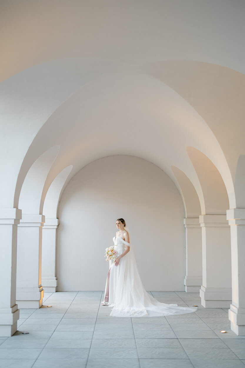 bride standing under archways