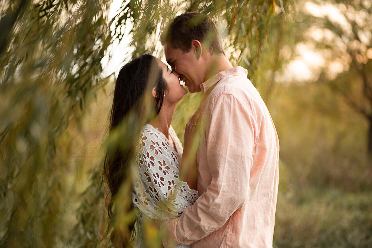 engagement-session-kissing-couple-laughing