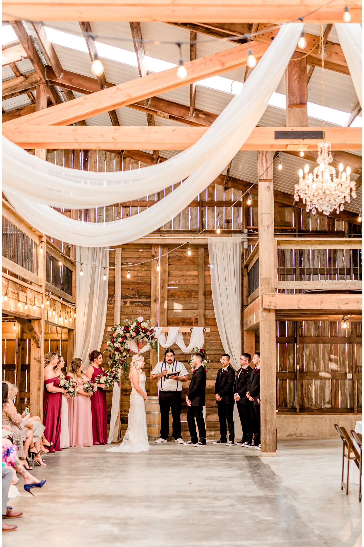 Wedding ceremony in a rustic barn at Springwater Lake Estates.