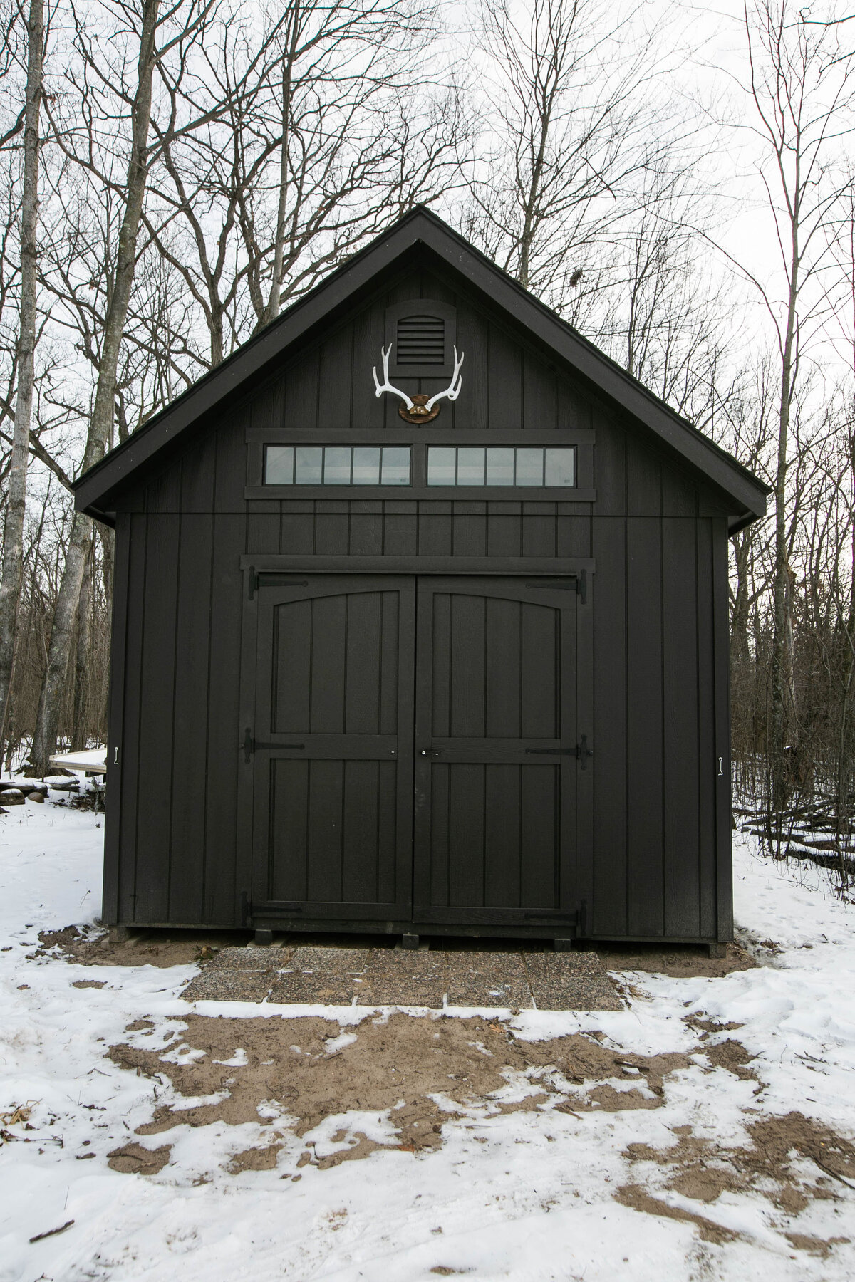 Exterior back view of custom home in Elk River, Minnesota with black shed