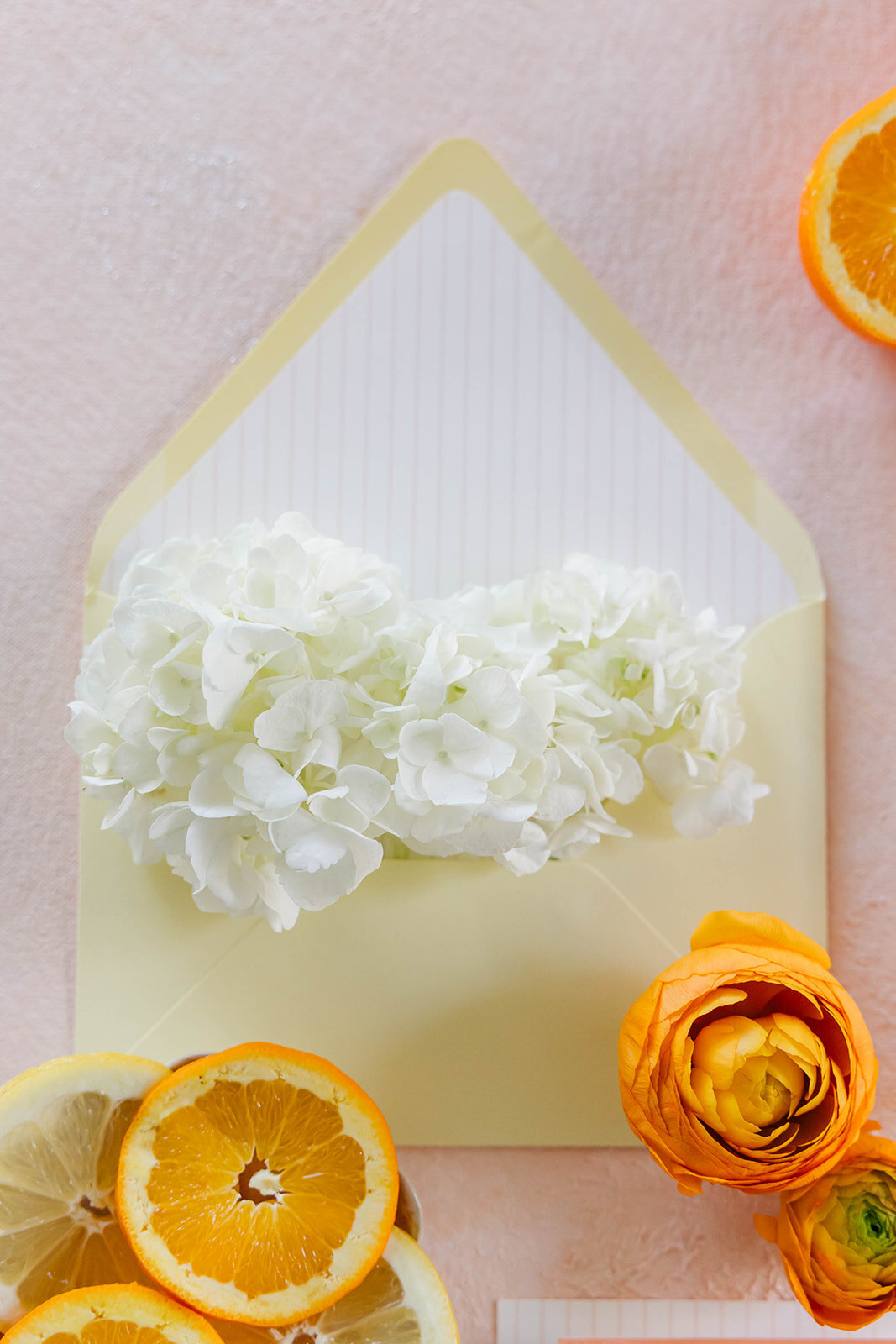 envelope-and-citrus-flatlay-yellow-striped-liner