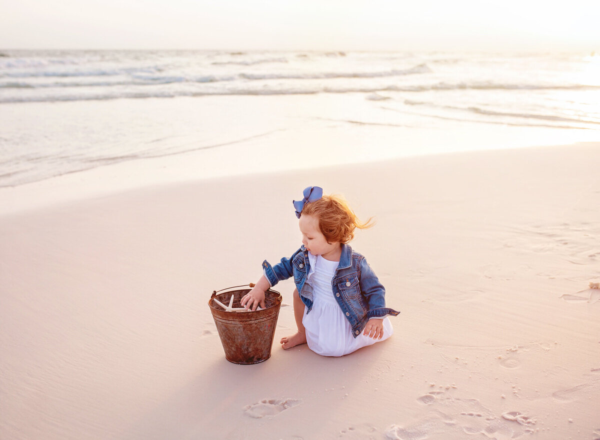 toddler-with-bucket-of-seashells-on-navarre-beach