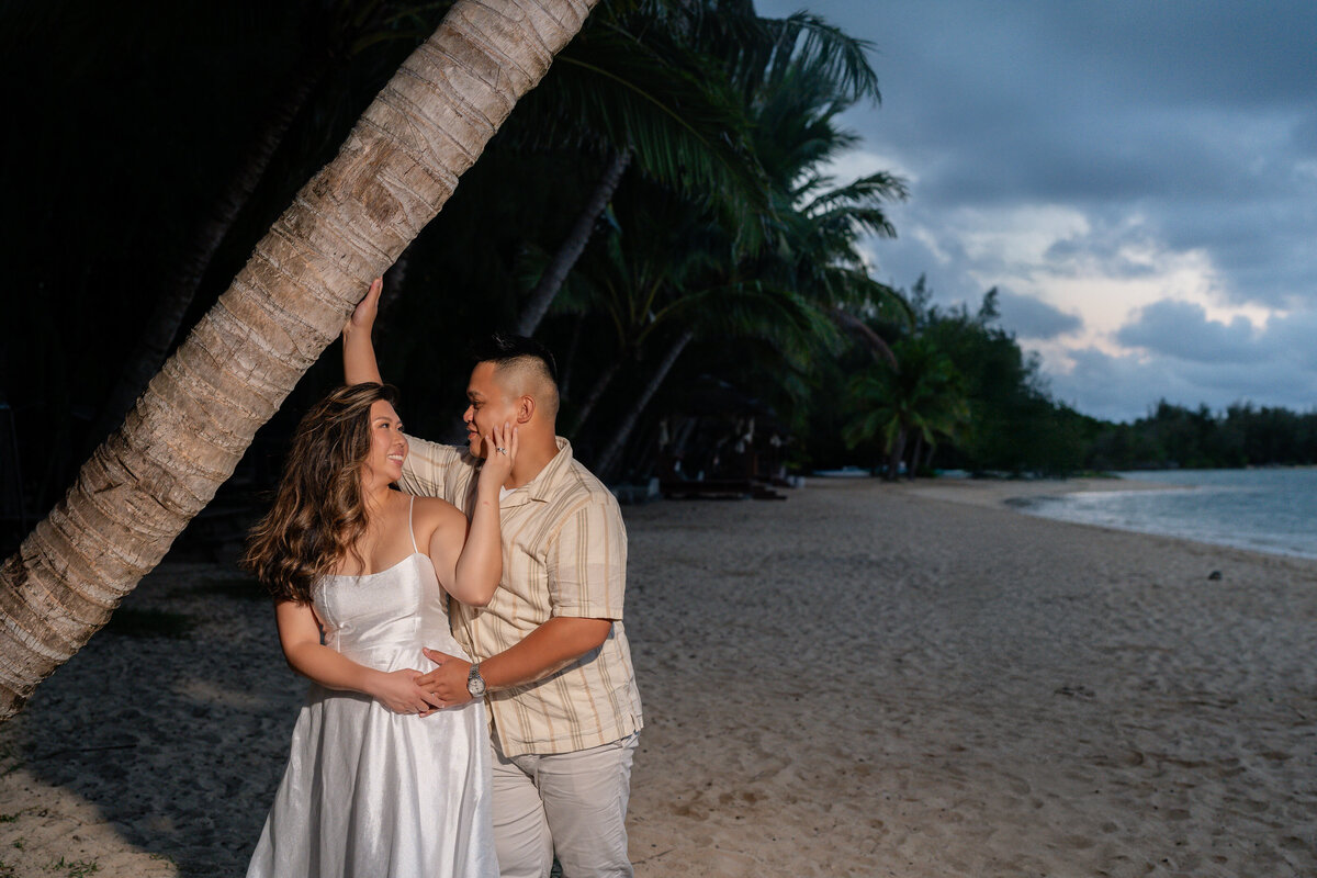 Oahu Hawaii Elopement Adventurous Asian couple at Secret Island Beach during blue hour at night with off camera flash.