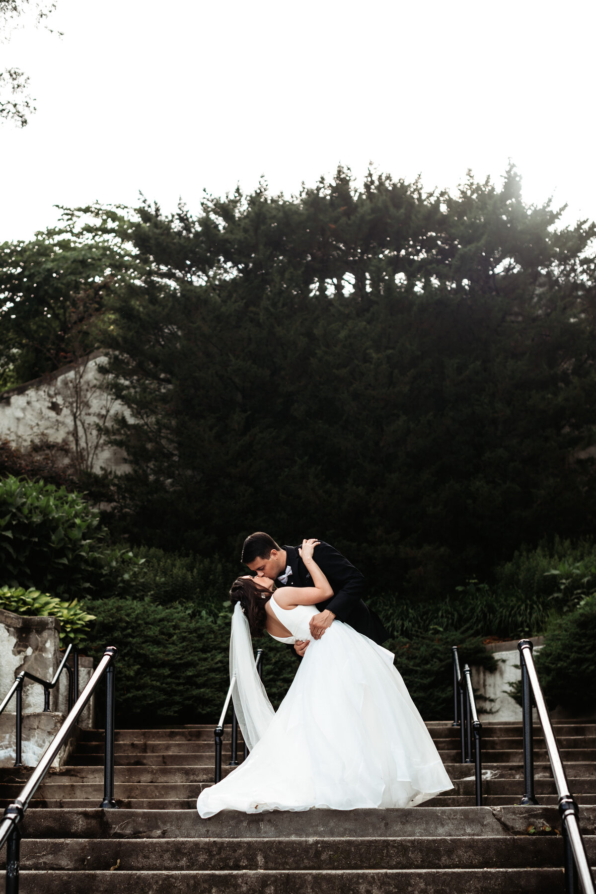 Bride and Groom kissing at Lake Park stairs