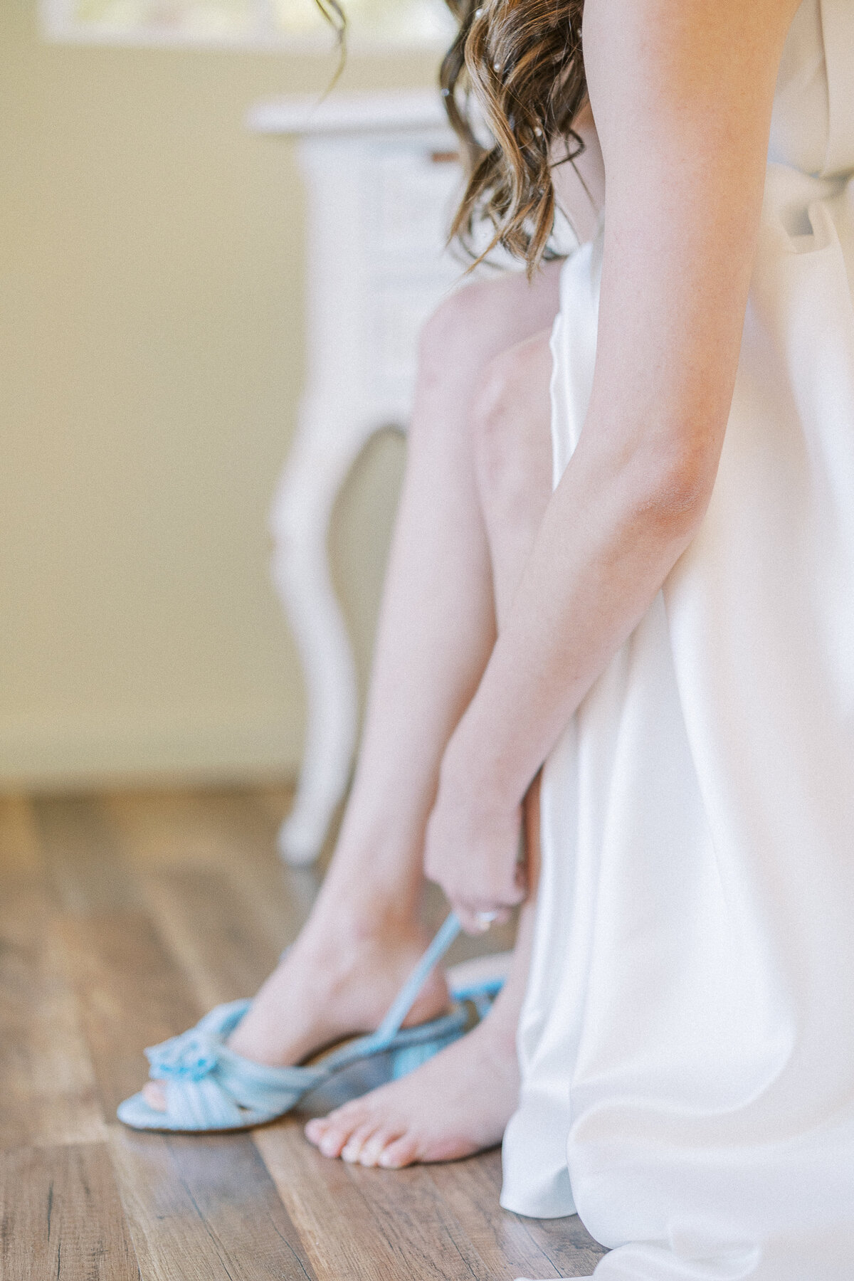 bride putting on shoes getting ready photos