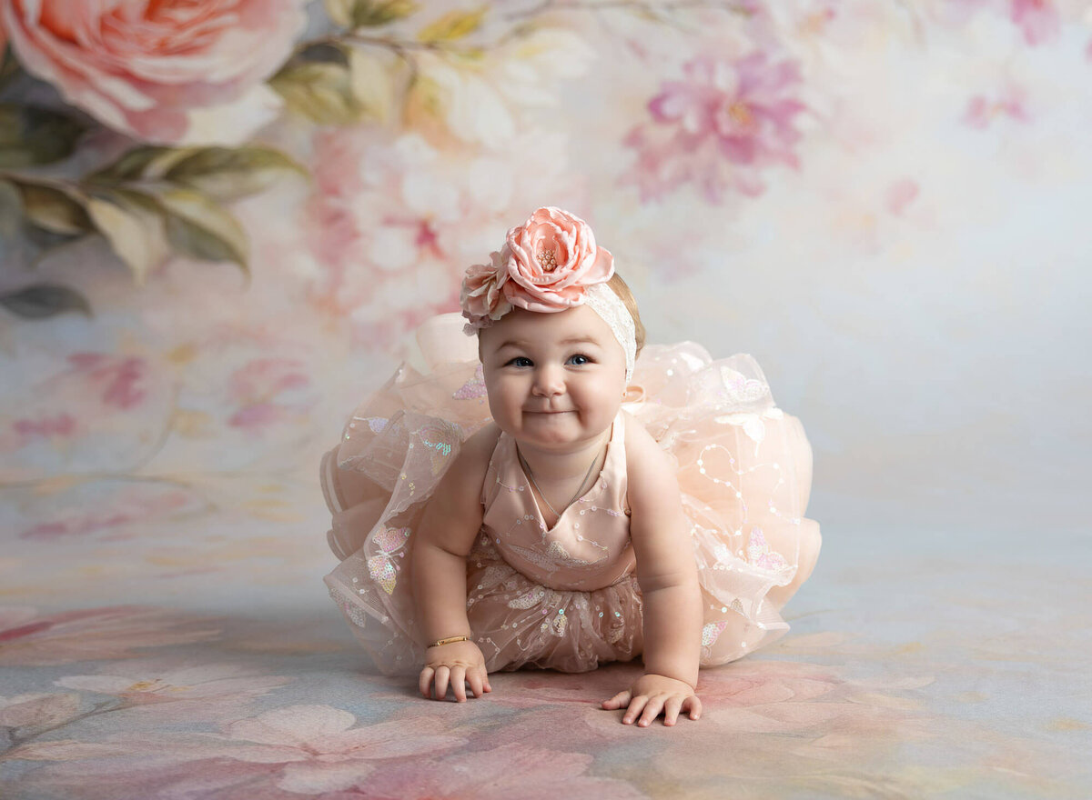 Girl celebrating first year birthday with floral headband and couture gown for photoshoot in La Vernia