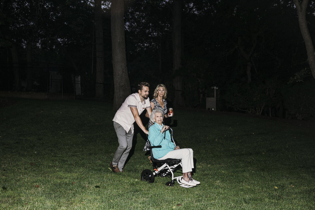 Photo of grandmother, mom and son in private backyard party by Mira Park Photography NY based wedding photographer