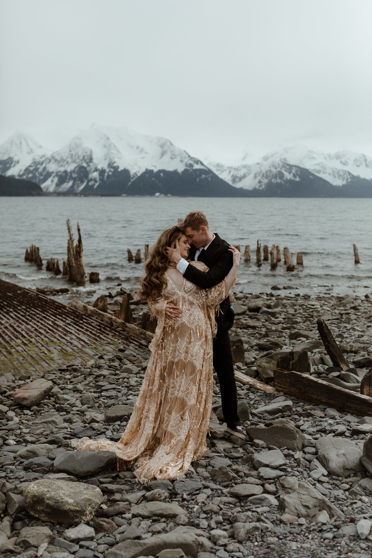 bride and groom kissing on dock