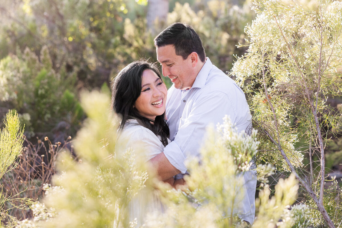 couple standing in bushes in bonita san diego