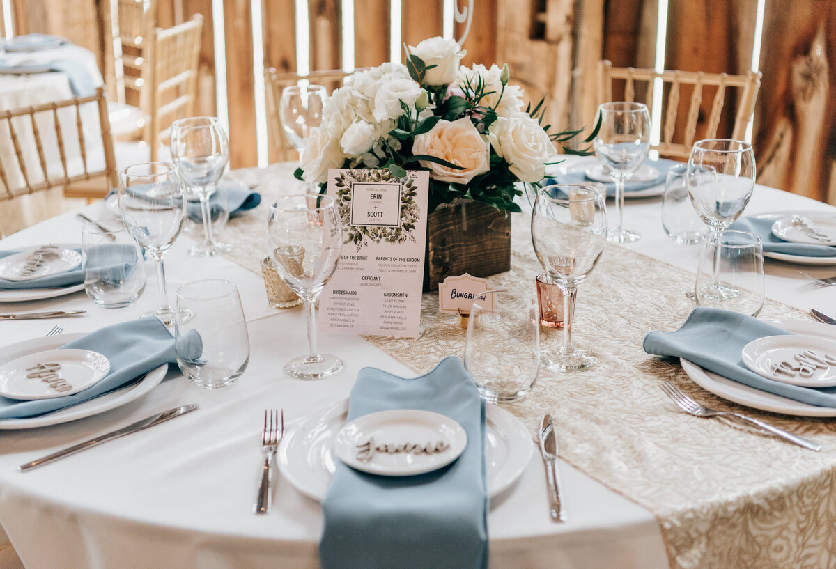 Elegant blue, white, and gold wedding dinner reception at Willow Creek Barn photographed by Nova Markina