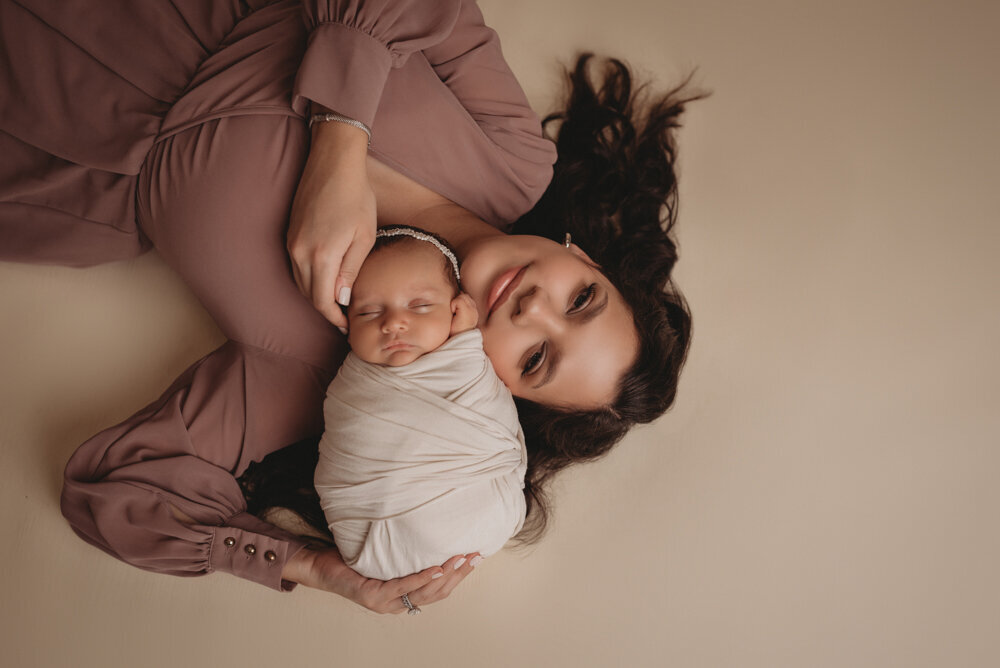 Mom and baby posing together for newborn session at Atlanta, Georgia newborn photographer studio