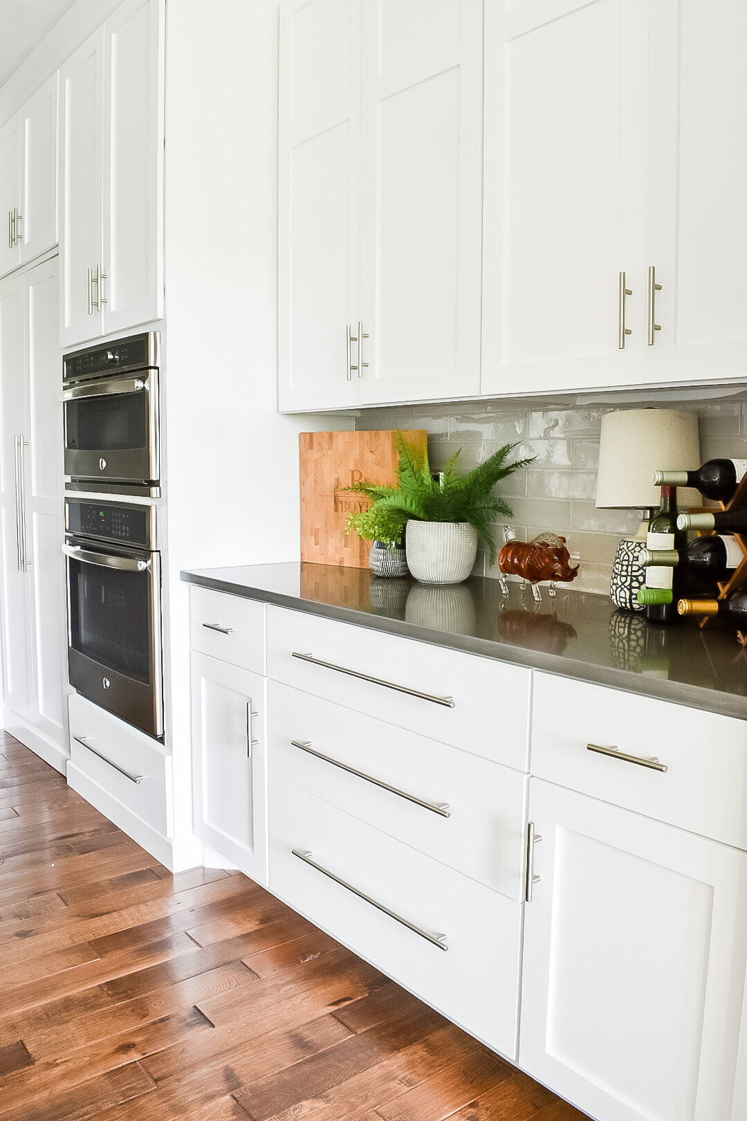White kitchen cabinets with stainless steel hardware