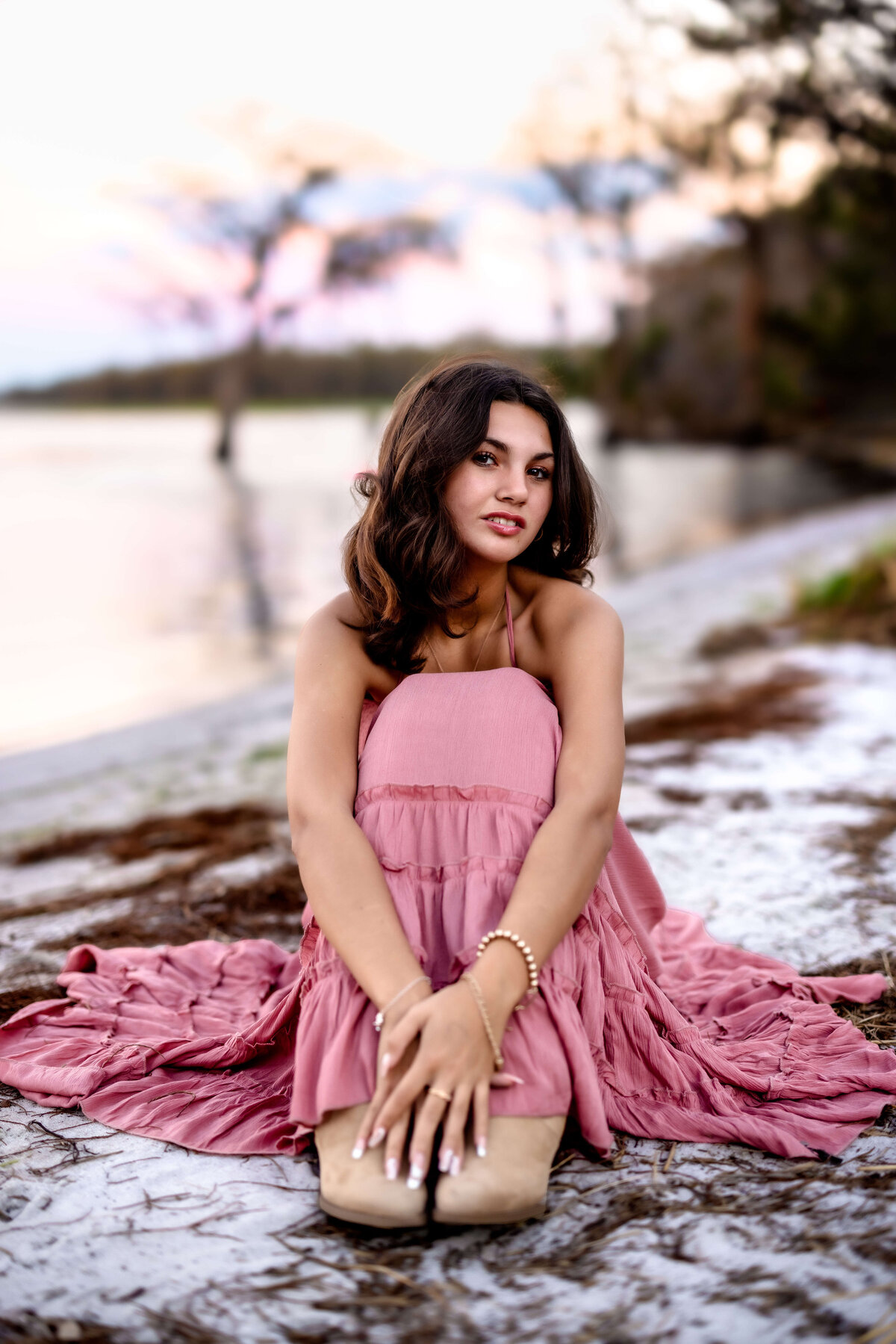 Moody pose on the sandy shoreline of a lake in Central Florida for a senior session