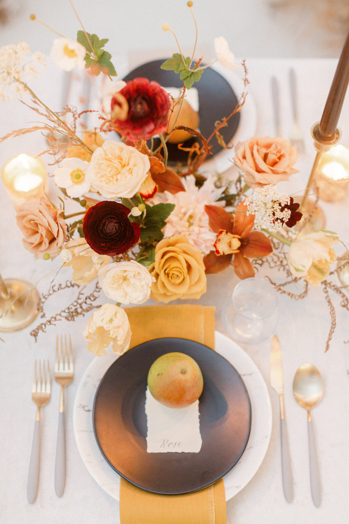 A beautiful garden centrepiece of red and orange flowers at a Montreal wedding reception.