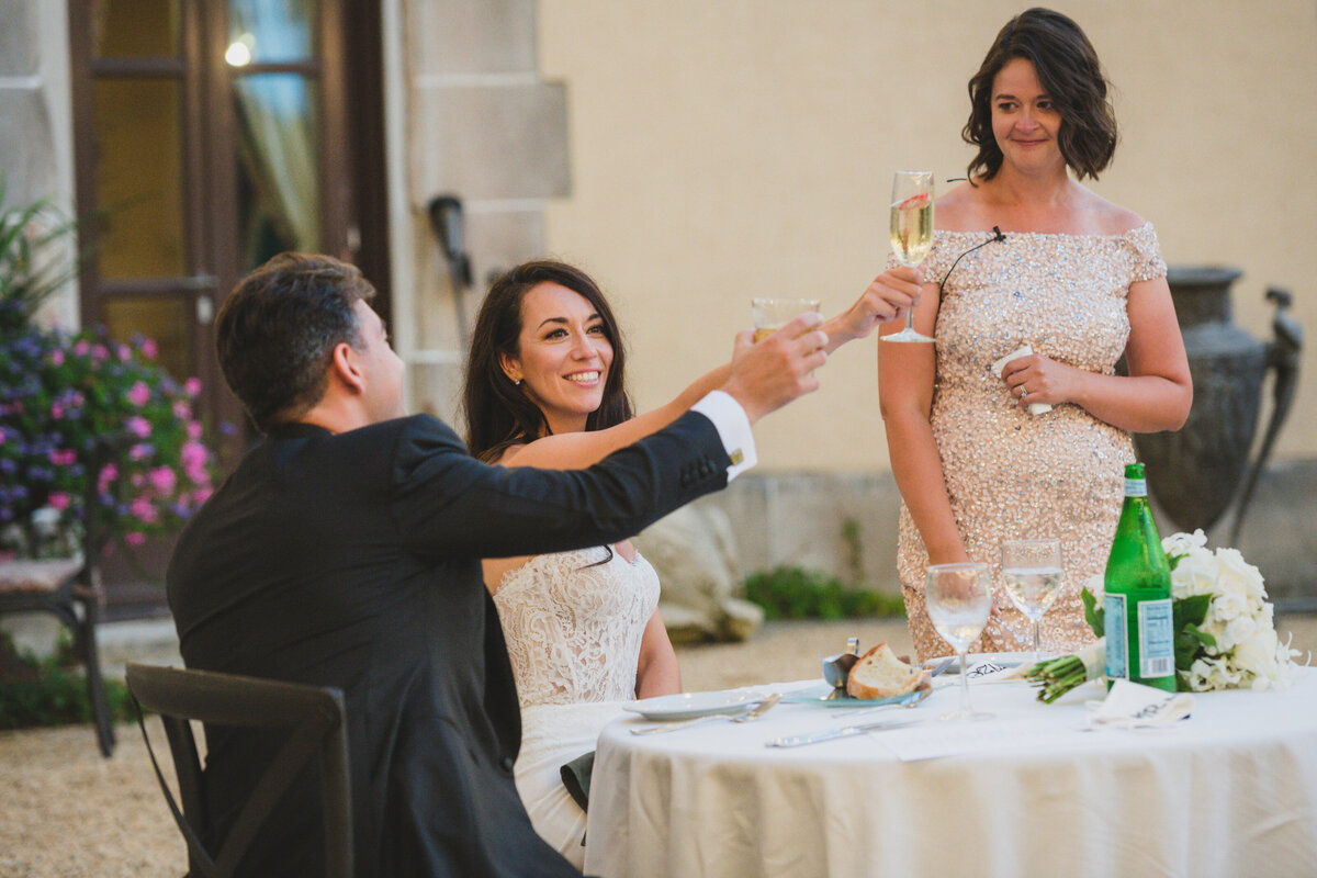 bride and groom raising a toast at Oheka Castle