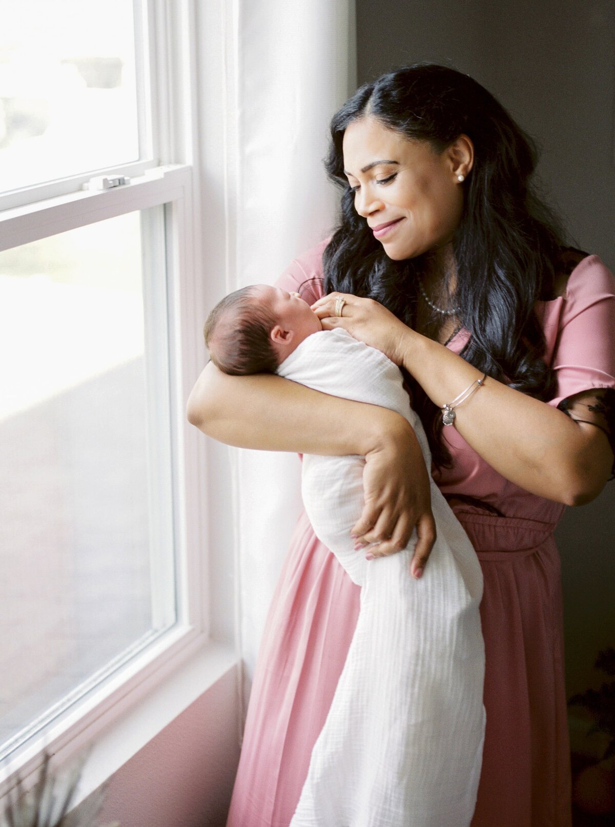 mother-carrying-newborn-baby