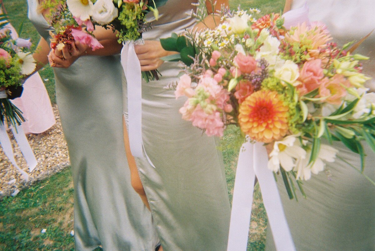 Bridesmaid holding bouquet of colourful flowers