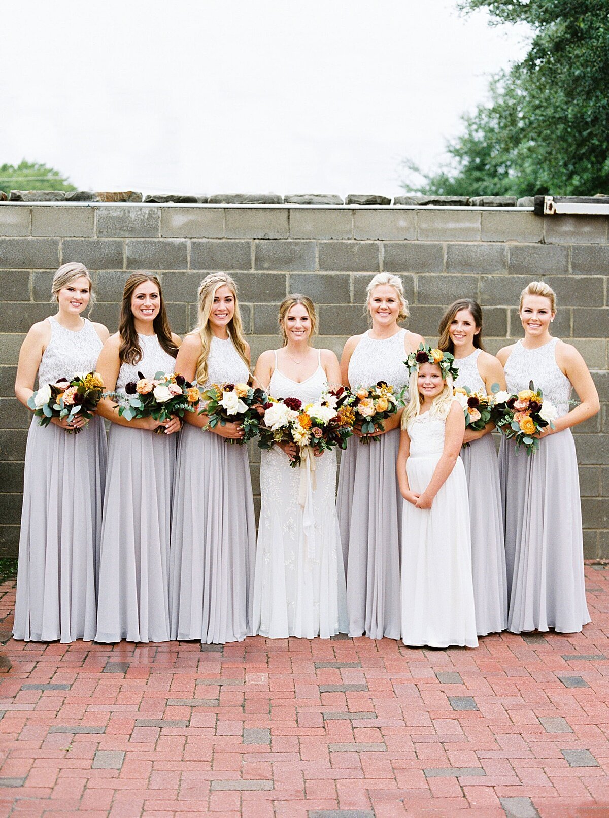 Bridesmaids with Fall floral bouquets at Mopac Event Center in Forth Worth, Texas | Vella Nest Floral Design
