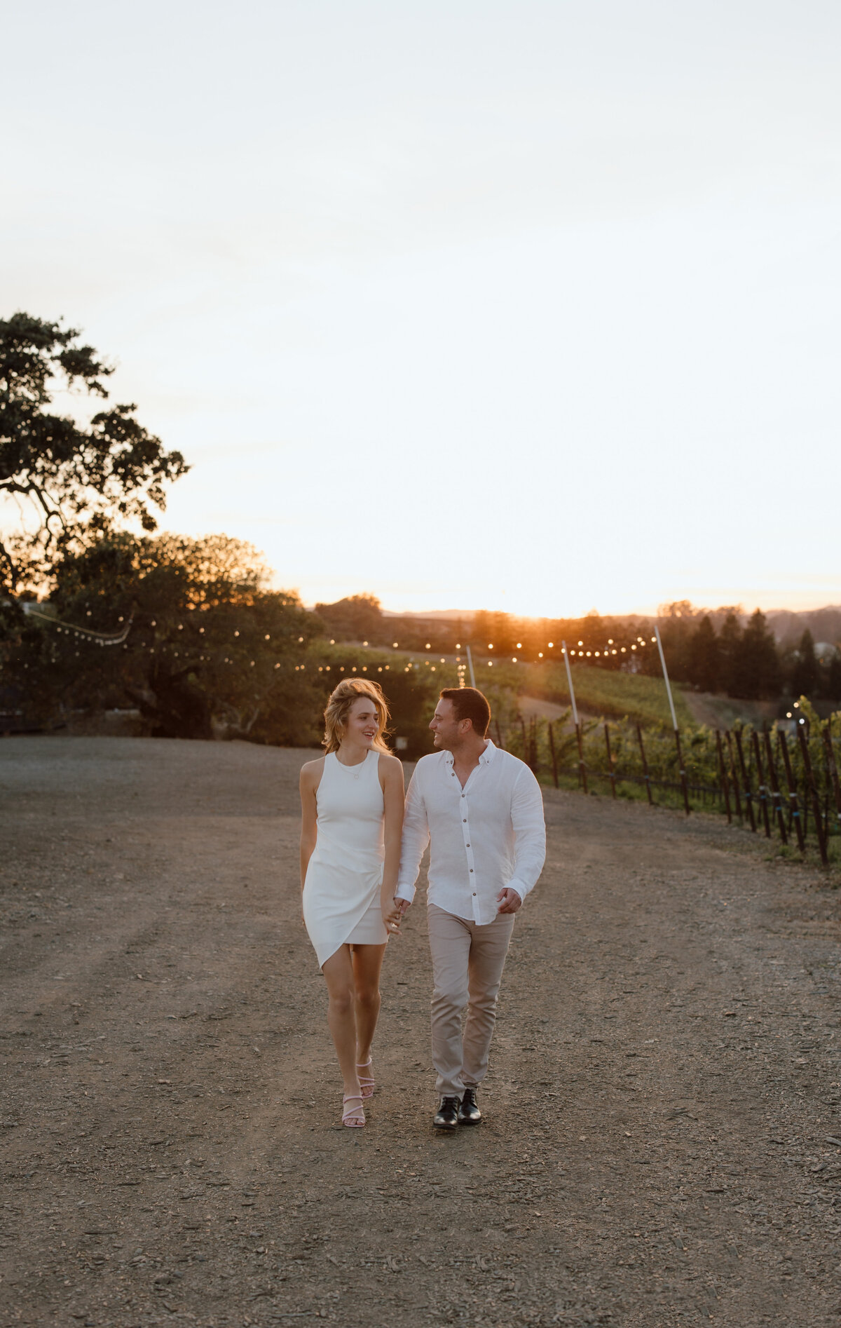 Couple slow jogs surrounded by the sunset and vineyards in napa valley