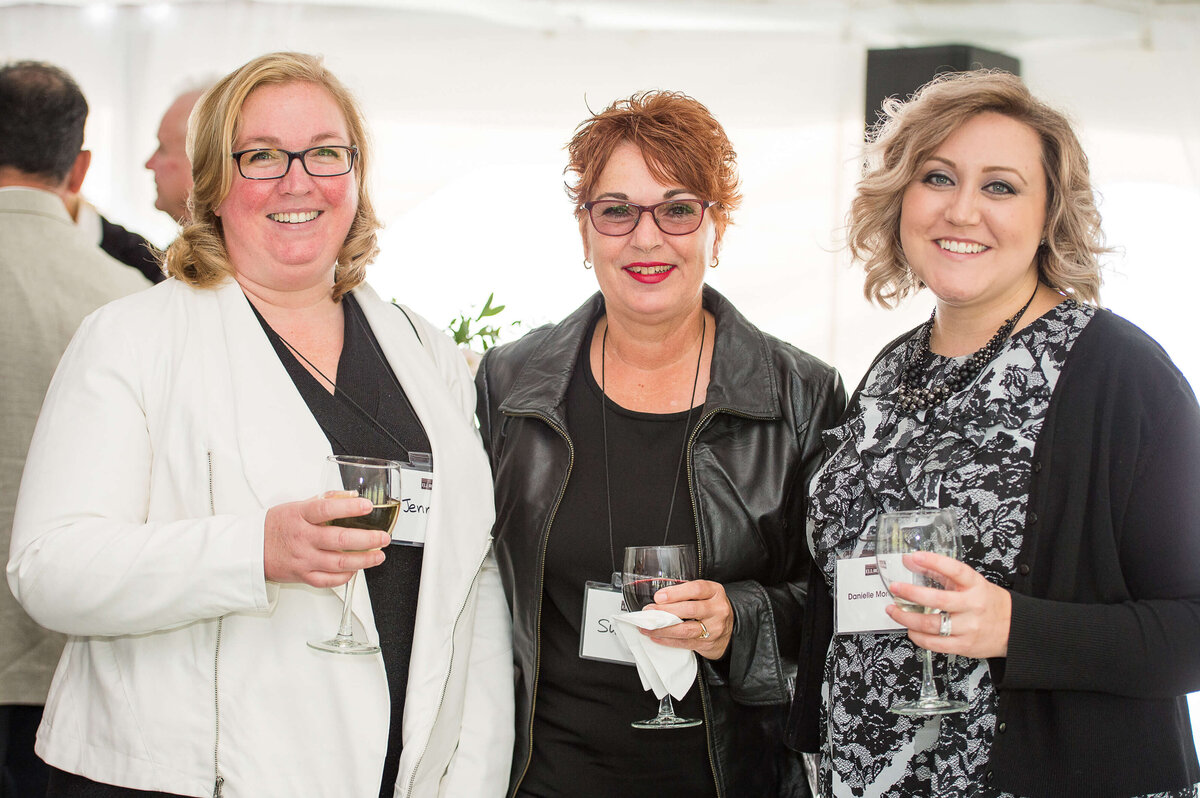 a photo of 3 smiling guests at Ell-Rod 25th Anniversary Celebration. Captured by Ottawa Event Photographer JEMMAN Photography COMMERCIAL   