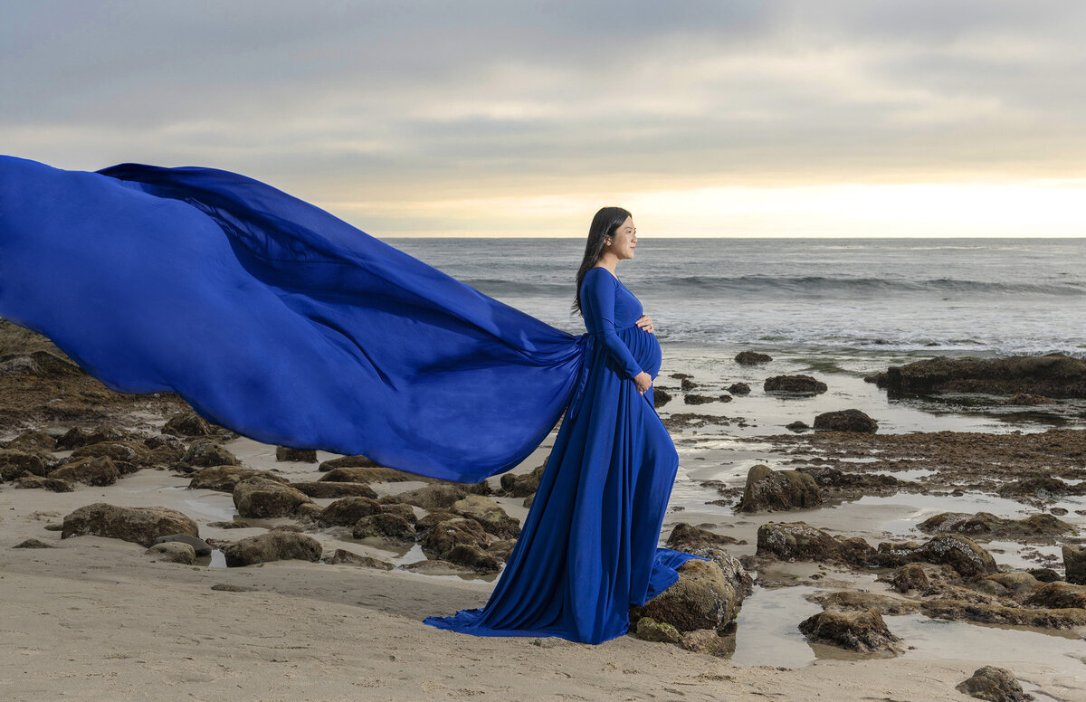 Blue-maternity-gown-on-beach-at-sunset