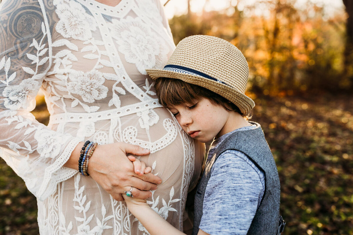 boy hugging mom pregnant belly-01