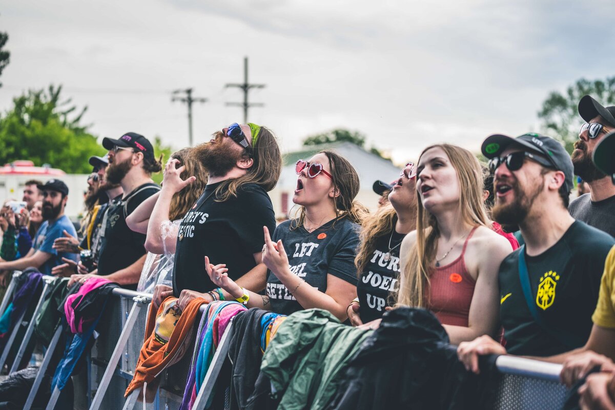 fans of umphreys mcgee on the rail at a show in vermont