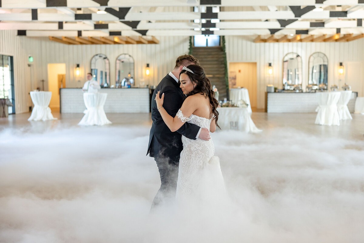 bride and groom dance in clouds at Milestone New Braunfels wedding