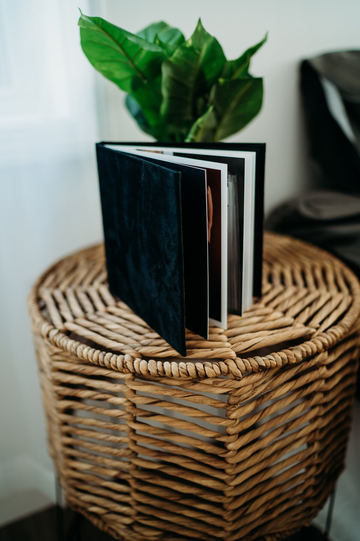Details of a luxury boudoir photo album sitting on a wicker side table