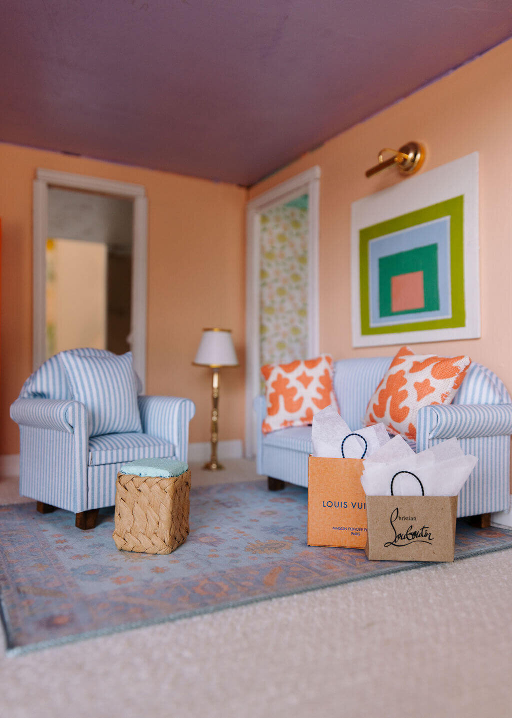 oyster creek studios petite palm beach dollhouse orange wall with modern art and shopping bags blue couch in living room