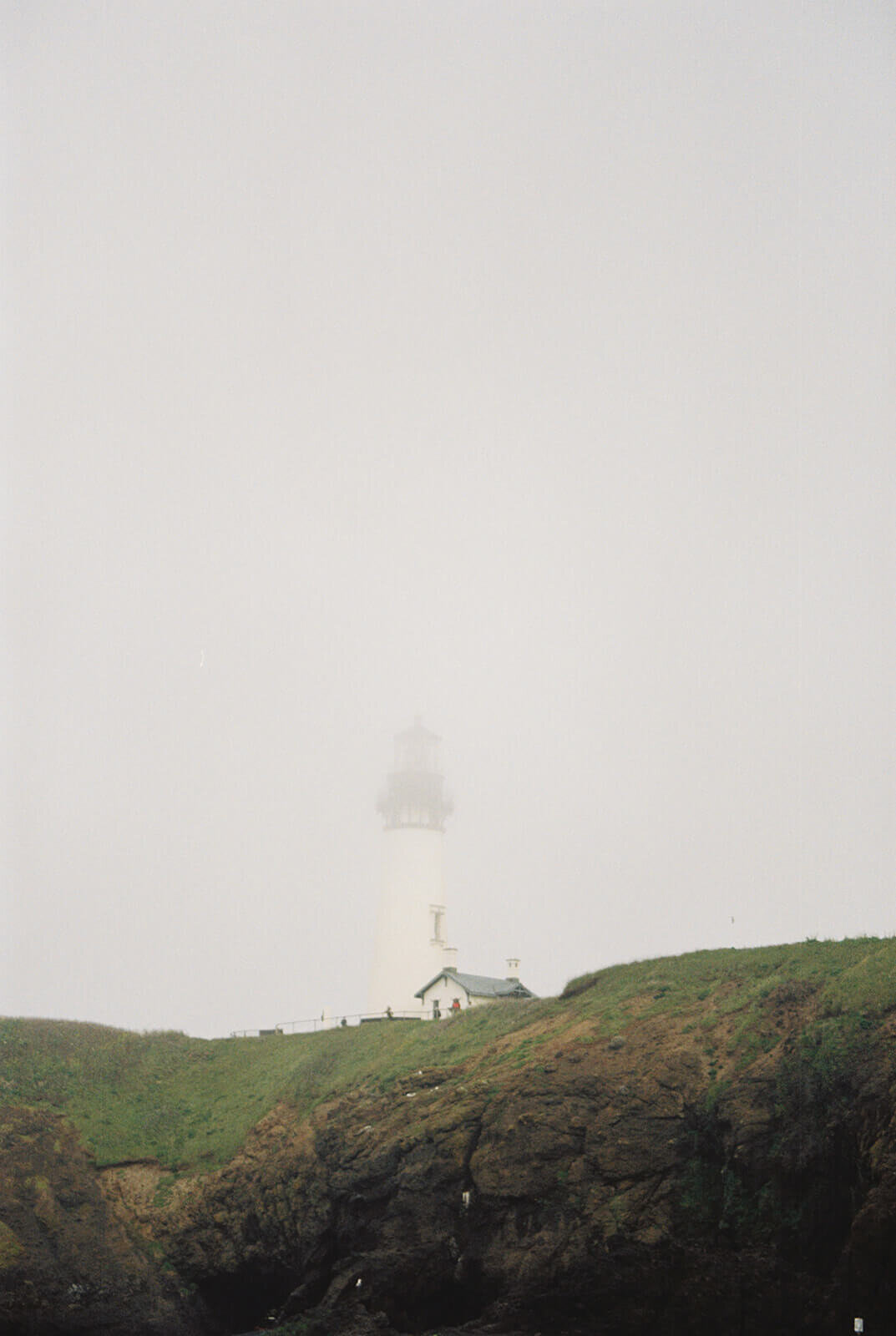 A foggy picture of Yaquina Head Lighthouse on the Oregon Coast. 