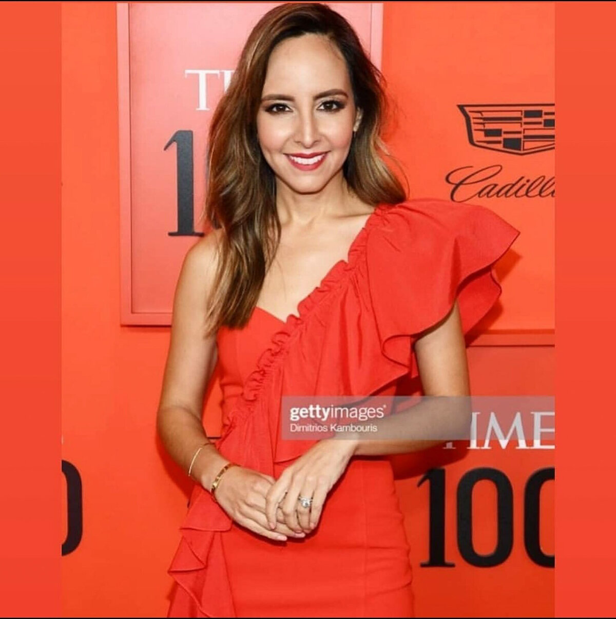 Bold red lip and glowing skin captured in a red carpet setting – makeup artistry by Lyds Makeup.