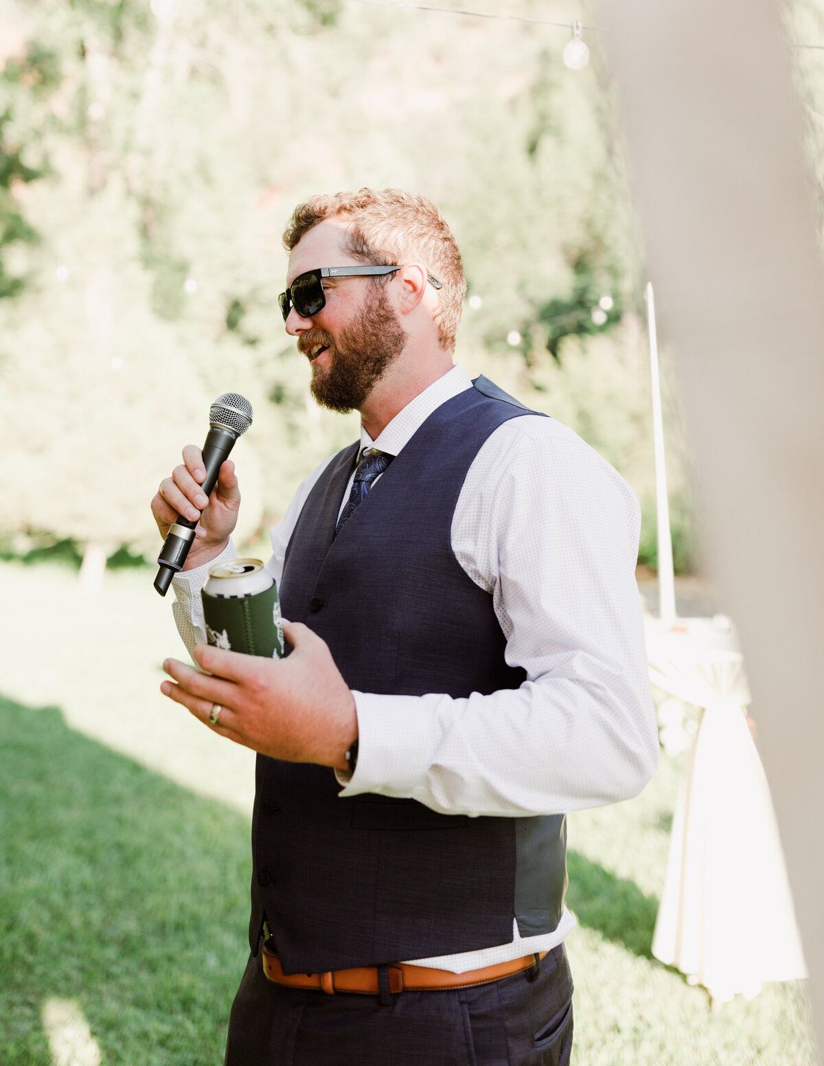 Man with microphone at Dallenbach Ranch Wedding reception Colorado