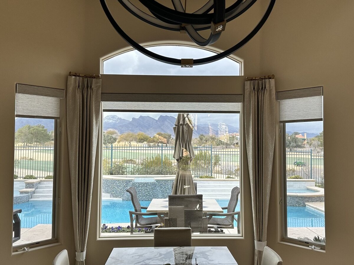 Custom drapery on a bay window with a mountain view