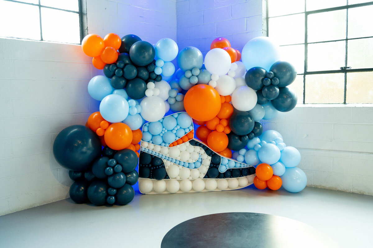 Bold blue and orange balloon décor for a basketball-themed bar mitzvah in Englewood Cliffs, New Jersey — playful, modern event styling with major impact.