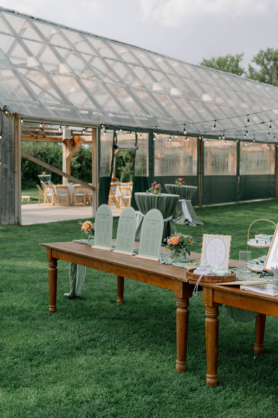 Wedding gift table styled with signage and décor, with the Cherry Barn reception building and orchard visible in the background.
